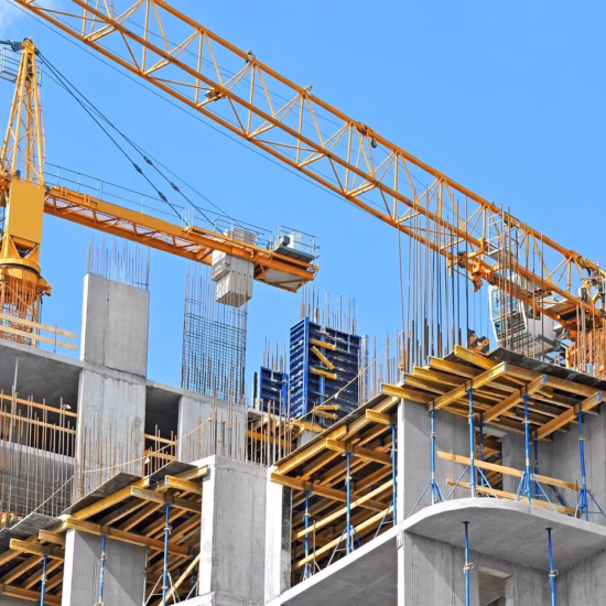 Construction work on a multi-story building with a crane on the construction site.