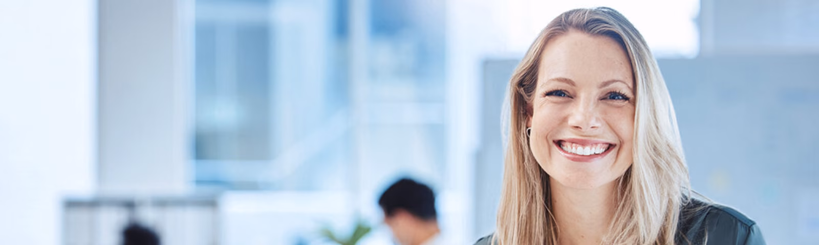 Professional portrait of an employee in a modern office setting.