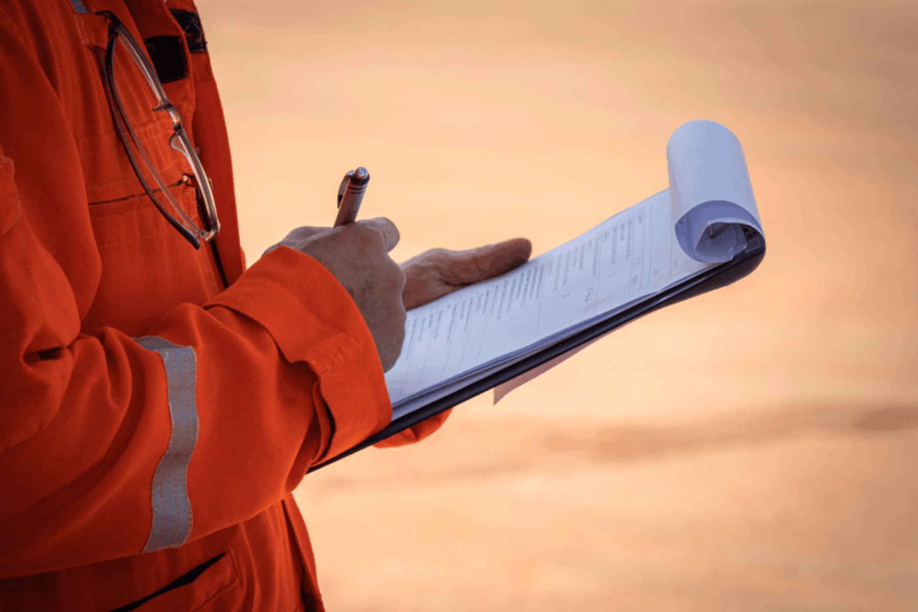 An employee records findings during an on-site inspection or check.