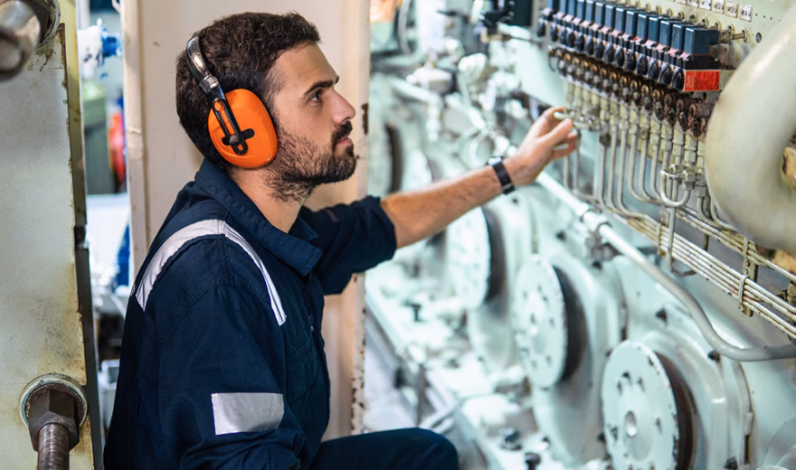 A technical system is being checked during inspection and maintenance work in an engine room.