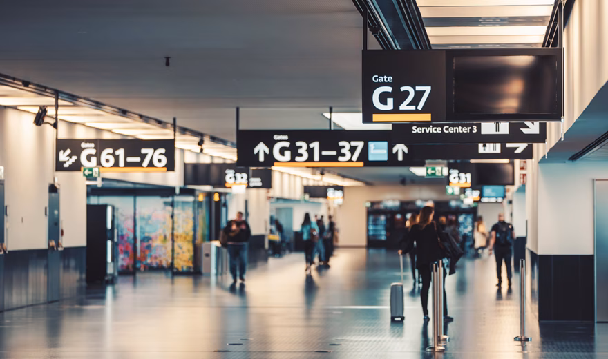 Signage at an airport helps travelers find gates and amenities.