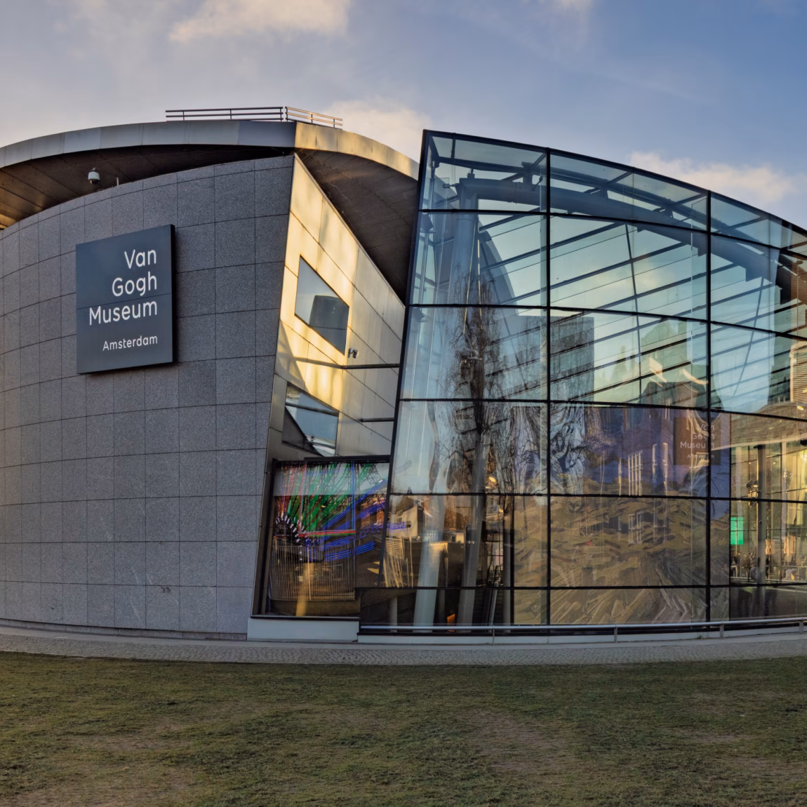 A modern museum building with striking architecture and a transparent glass facade.