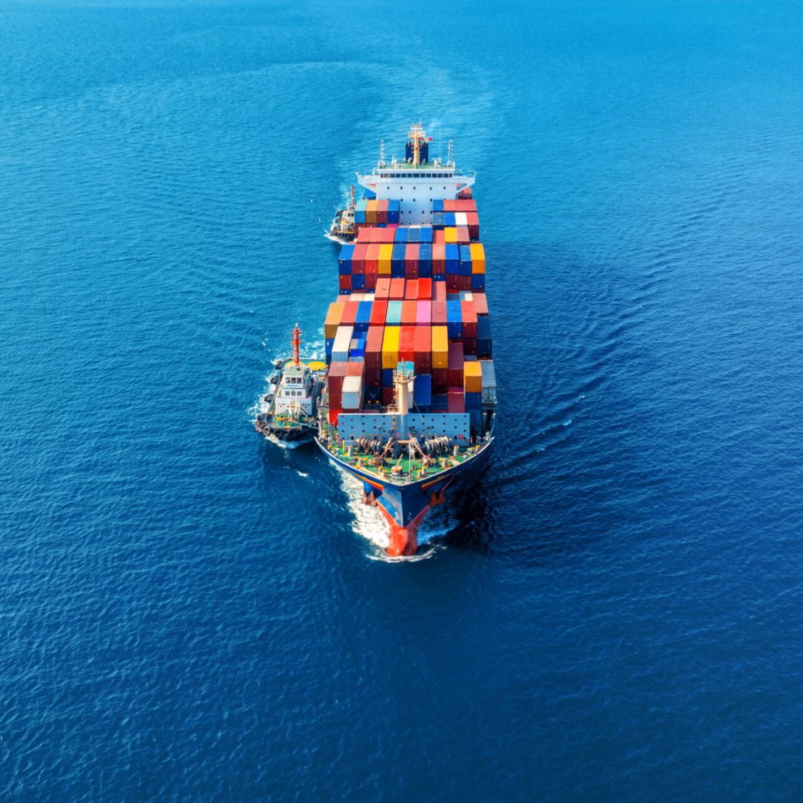 Aerial view of cargo ship with cargo container on sea.