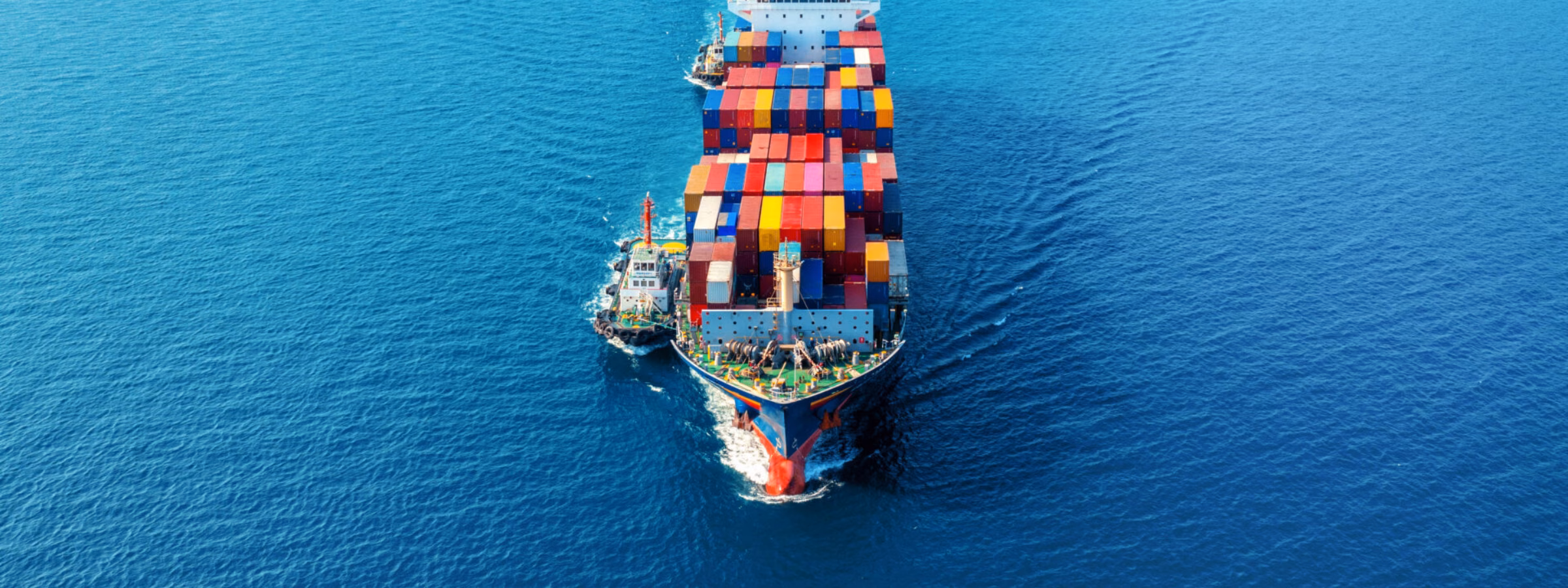 Aerial view of cargo ship with cargo container on sea.