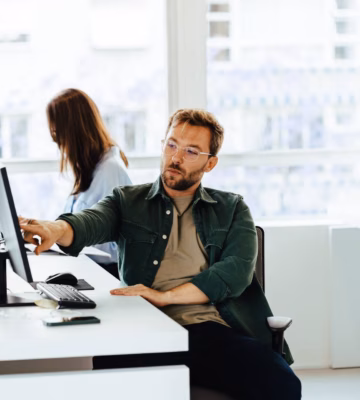 Employees discuss information and collaborate on tasks in a modern office environment.