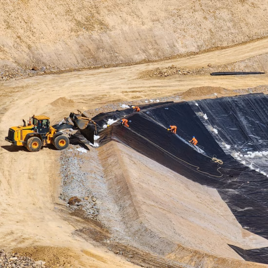 Work on an excavated basin involving the installation of a waterproofing membrane on the slopes.