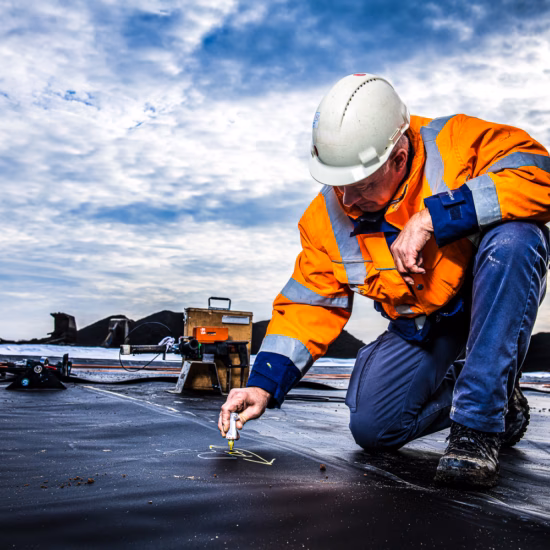 An inspector is inspecting a waterproofing system during on-site work.