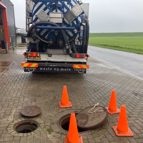 A truck is positioned to perform work on underground wells at an industrial site.