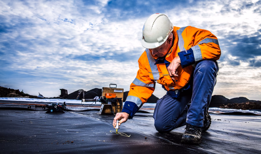 An inspector is inspecting a waterproofing system during on-site work.