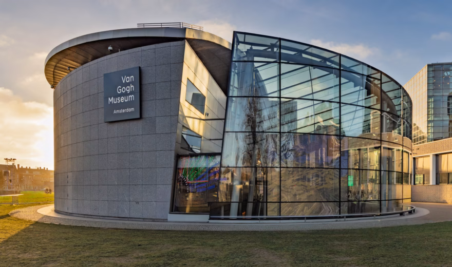 A modern museum building with striking architecture and a transparent glass facade.
