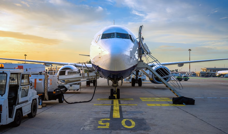 A passenger plane is being prepared for departure during ground handling operations at the airport.