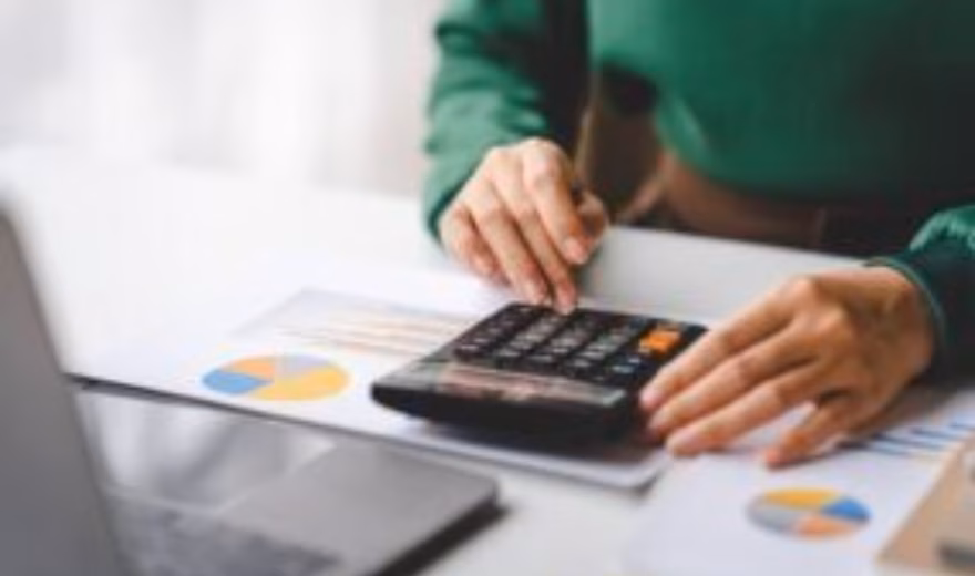 Financial data and charts are analyzed using a calculator and reports.