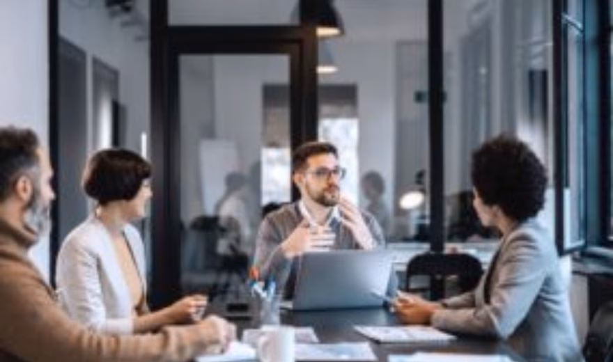 Employees discuss quality management during a meeting at the office.