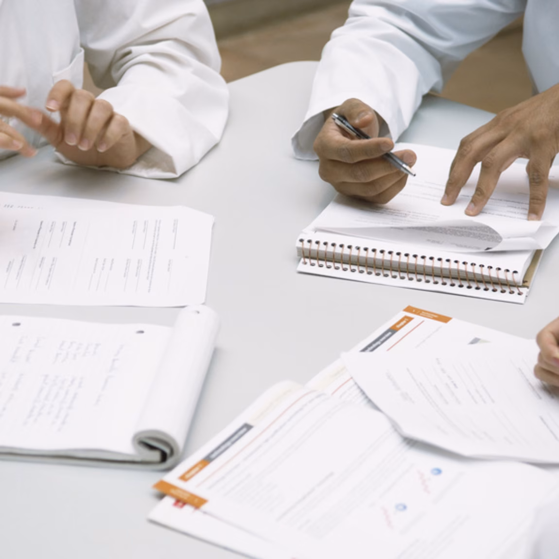 Colleagues doing paperwork together --- Image by © Fancy/Veer/Corbis