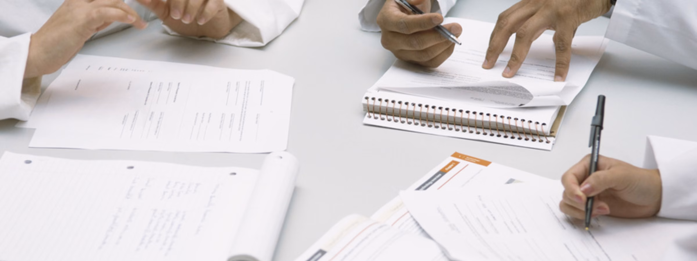 Colleagues doing paperwork together --- Image by © Fancy/Veer/Corbis
