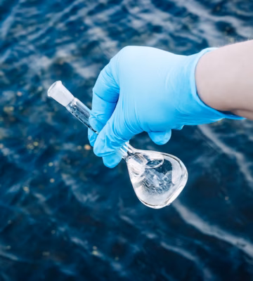 Een watermonster wordt genomen uit oppervlaktewater voor onderzoek naar waterkwaliteit en milieuparameters.