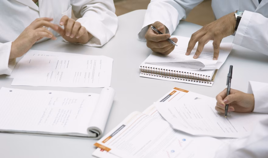 Colleagues doing paperwork together --- Image by © Fancy/Veer/Corbis