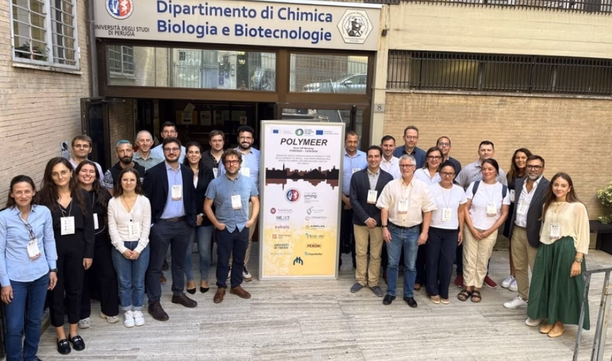 Participants pose for a group photo at an academic research or networking event venue.