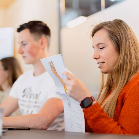 A participant reviews course materials during a training session in a professional learning environment.