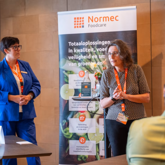 Presentations and knowledge sharing during a meeting on quality and food safety.