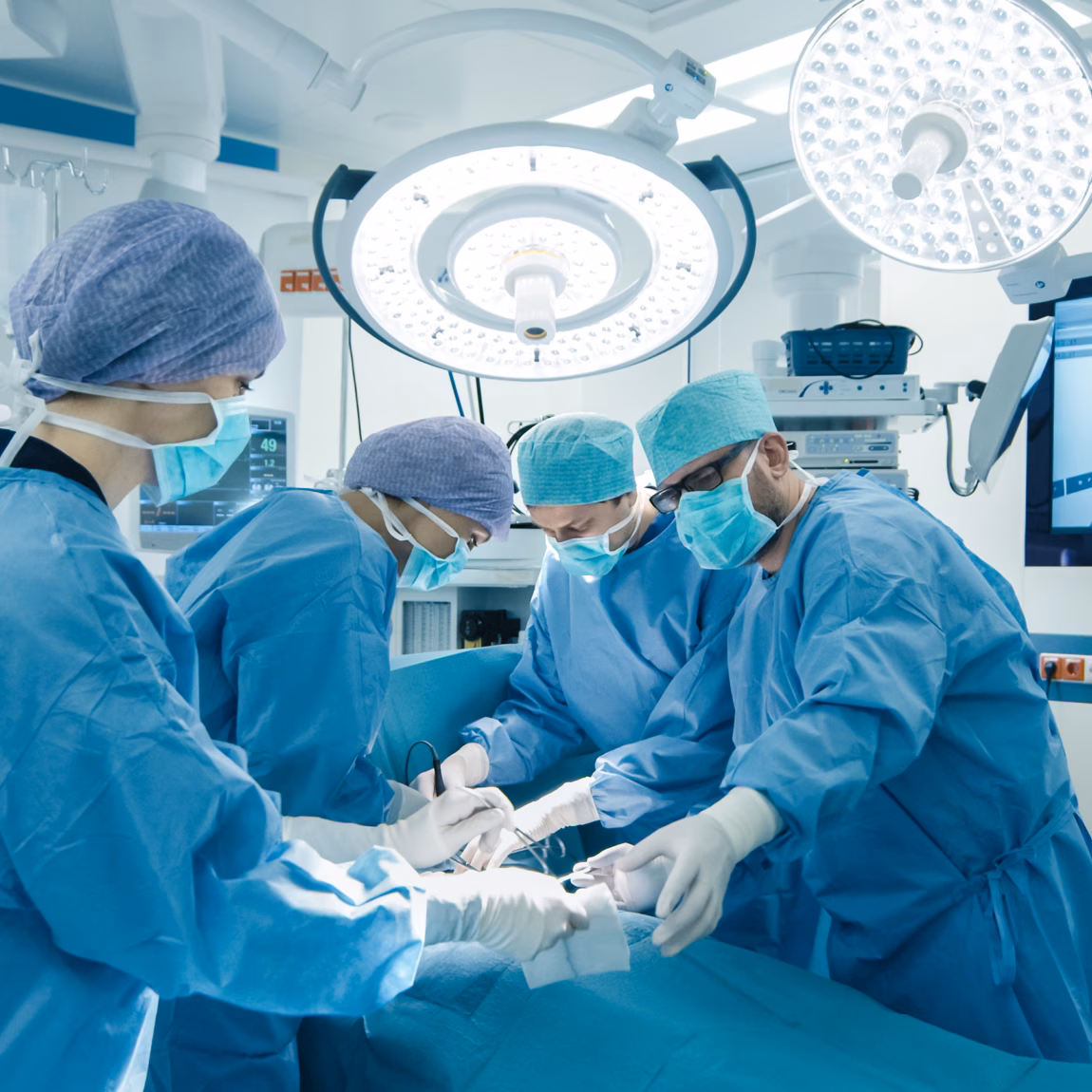 Medical Team Performing Surgical Operation in Bright Modern Operating Room
