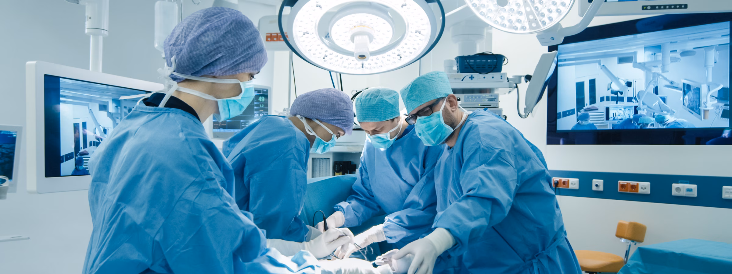 Medical Team Performing Surgical Operation in Bright Modern Operating Room