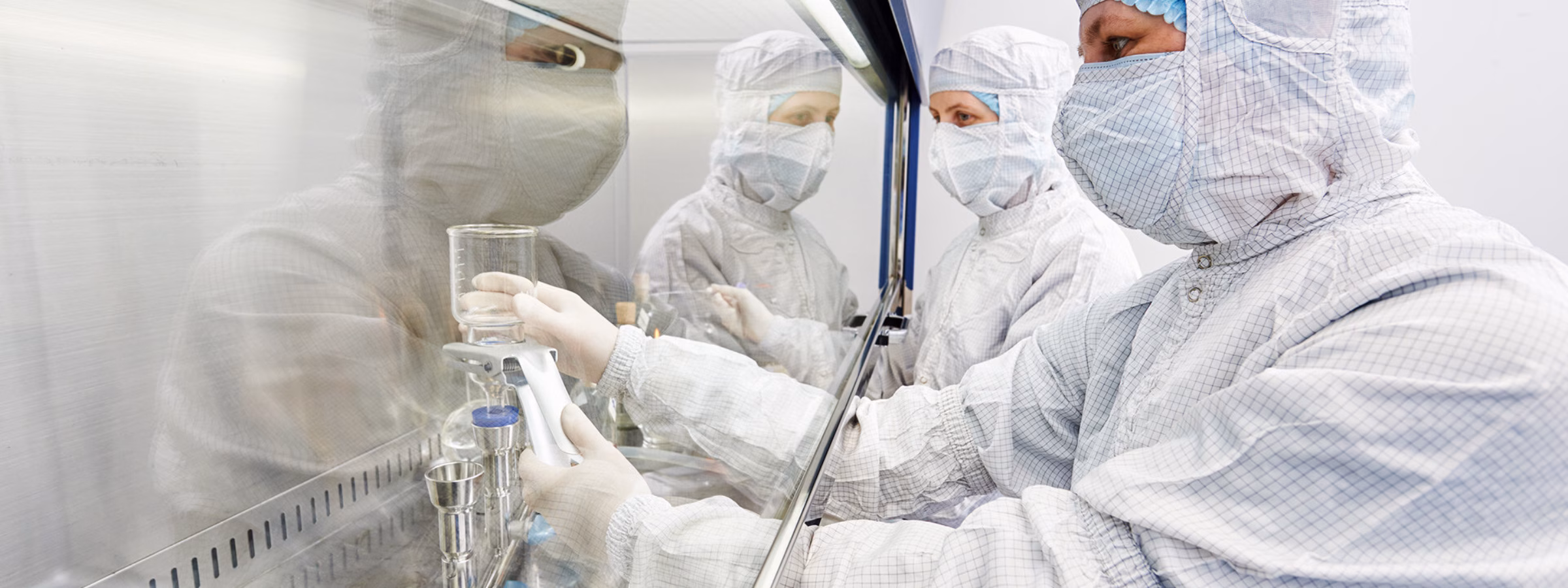 female science researcher in protective uniform and equipment works with dangerous hazard virus material at microbilogy laboratory
