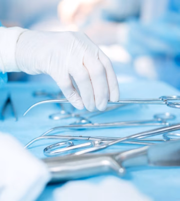 Steriele chirurgische instrumenten worden voorbereid op een afgedekte operatietafel voor een medische ingreep.