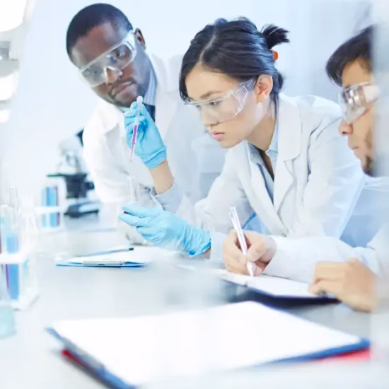 A team works together on a laboratory analysis using measuring equipment and samples.