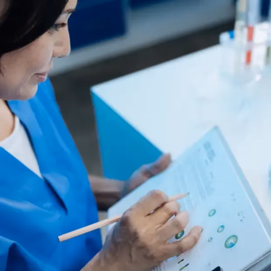 A lab technician evaluates measurement data and test results in a laboratory setting.