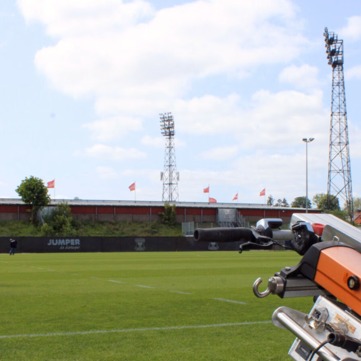 A machine is being used for maintenance work on a sports field.