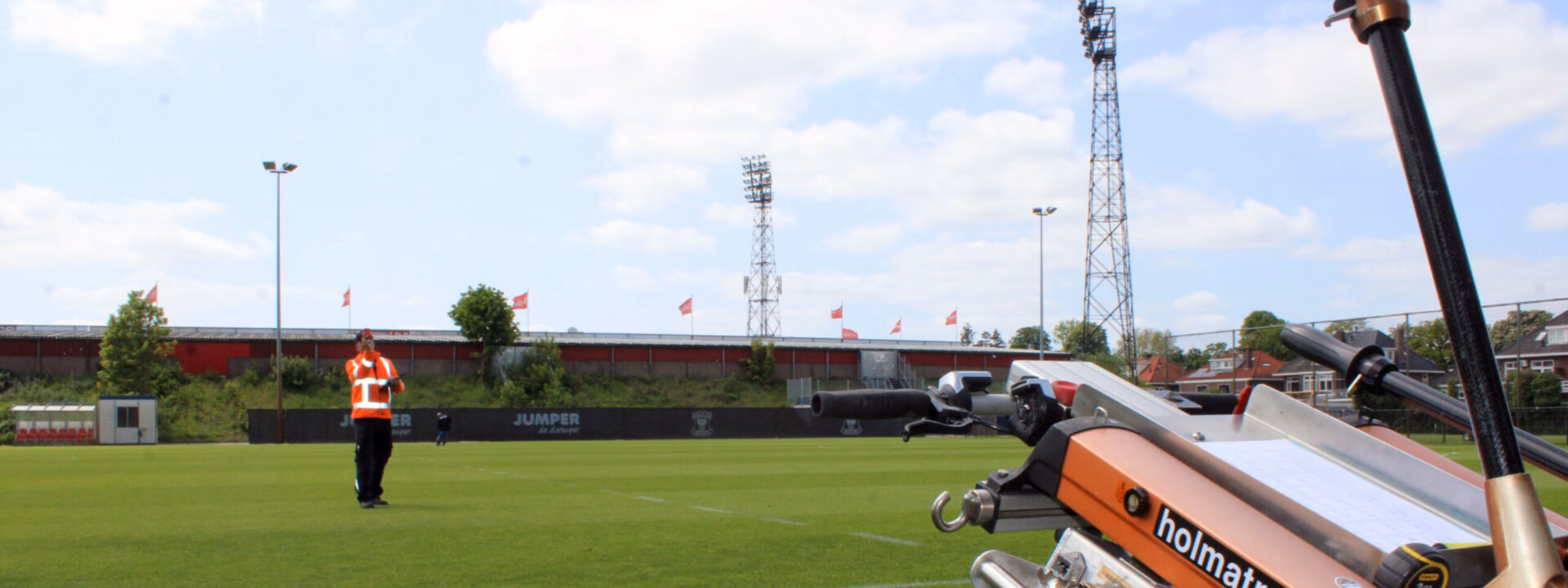 A machine is being used for maintenance work on a sports field.