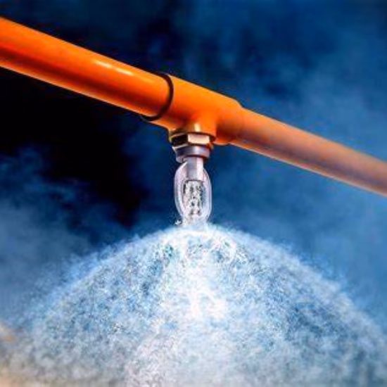 A sprinkler system disperses water as part of a fire protection system.