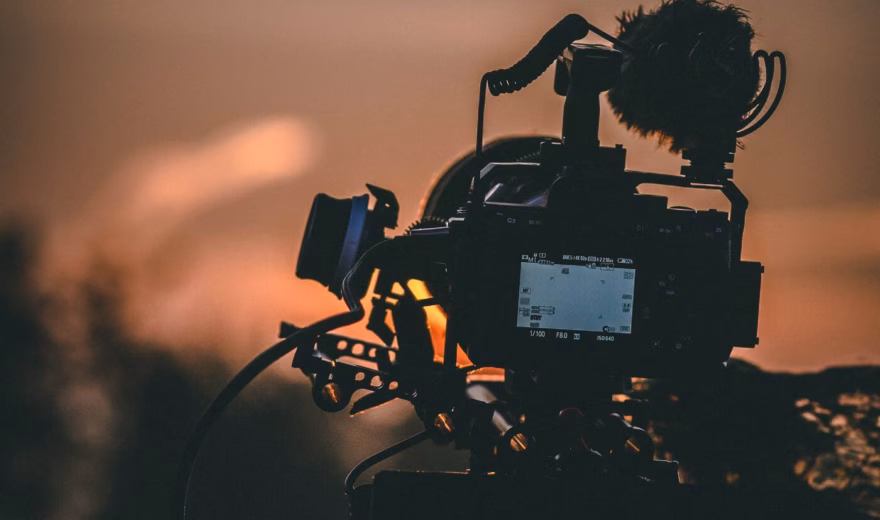 Professionele videocamera filmt een scène tijdens een opname bij weinig licht.