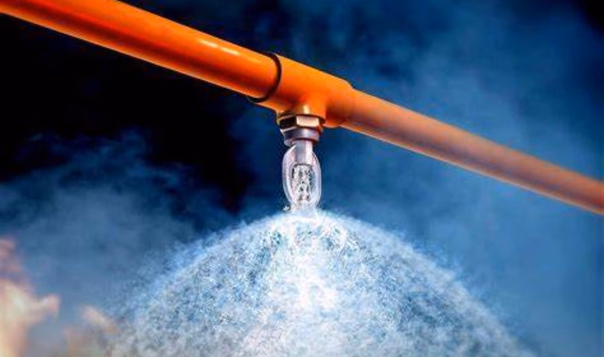 A sprinkler system disperses water as part of a fire protection system.