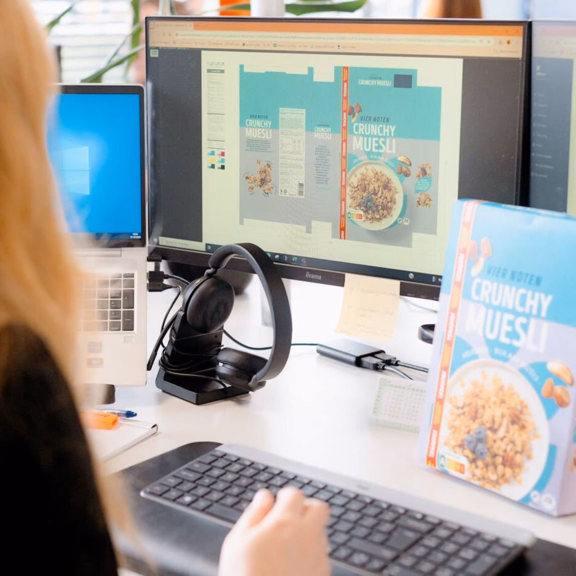 A woman is checking the label of muesli on a computer.