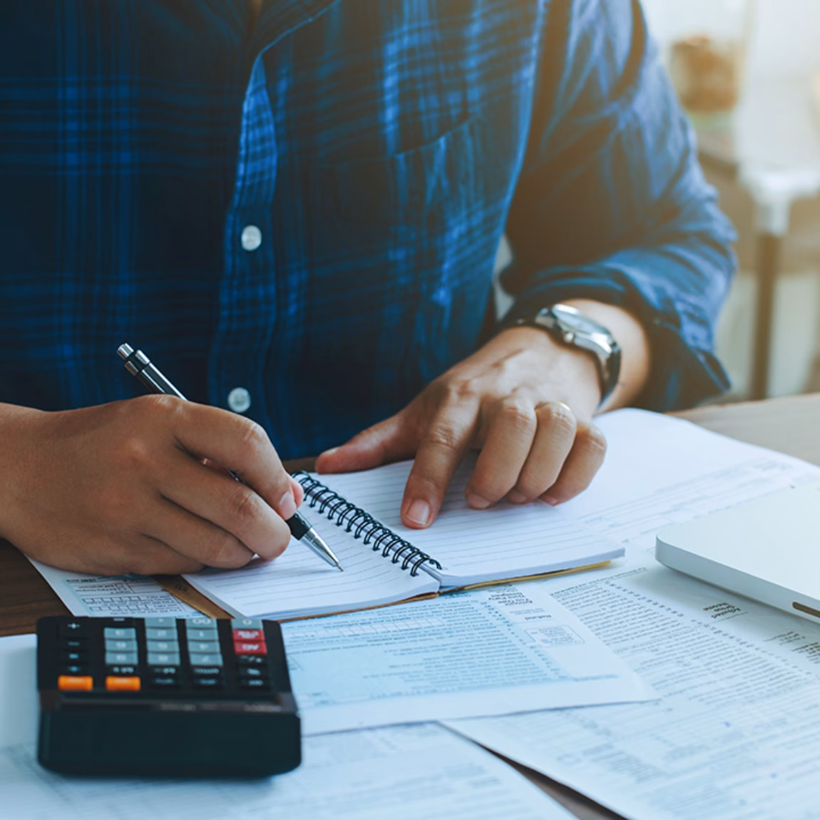 Man doing finances and calculate about cost to real estate investment and in other, tax system.Time for Taxes Money Financial Accounting Taxation Concept