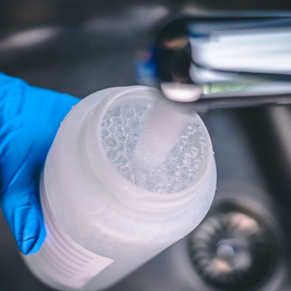 A water sample is collected for water quality analysis in the laboratory.