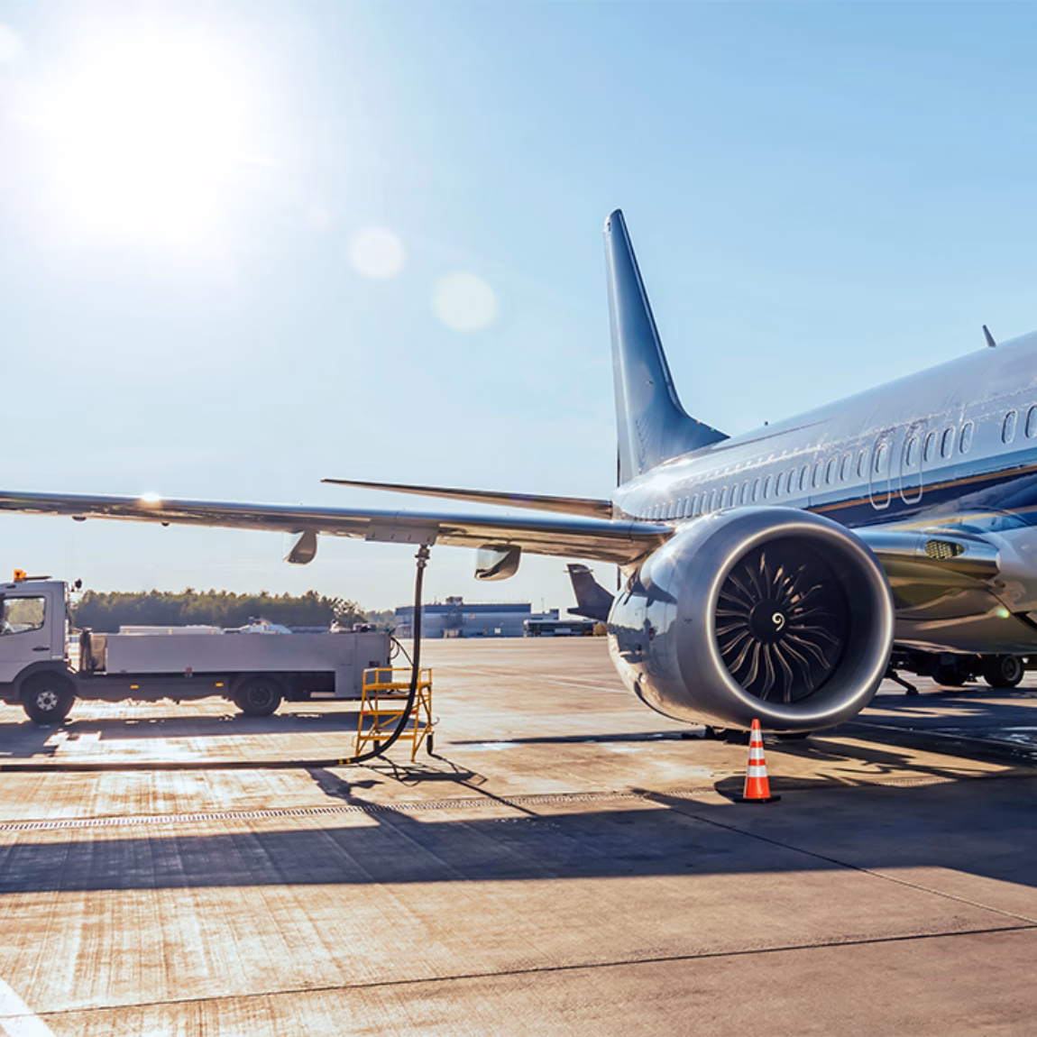 An airplane is on the airport apron while ground handling operations are being carried out.
