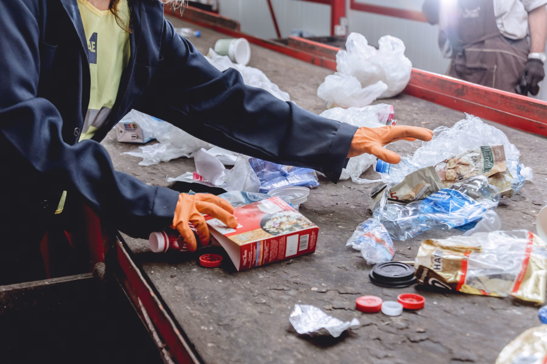 Workers are sorting trash for separate collection and processing.