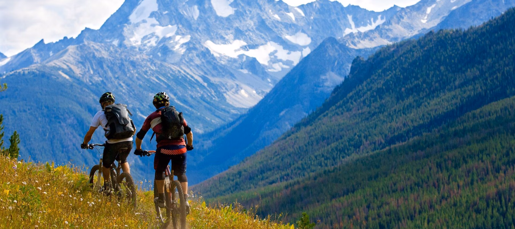 Two male mountain bike riders enjoy a cross-country trail in British Columbia, Canada.