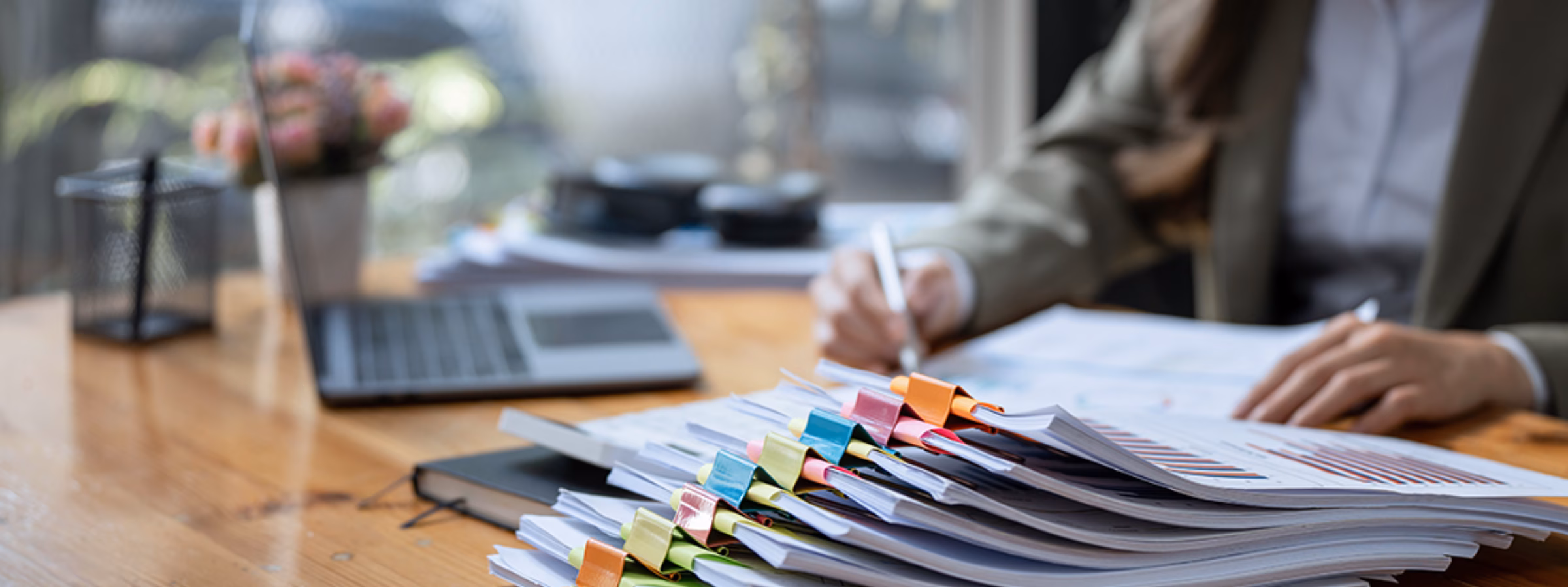Business Documents concept : Businesswoman working in Stacks of paper files for searching and checking unfinished document achieves on folders papers
