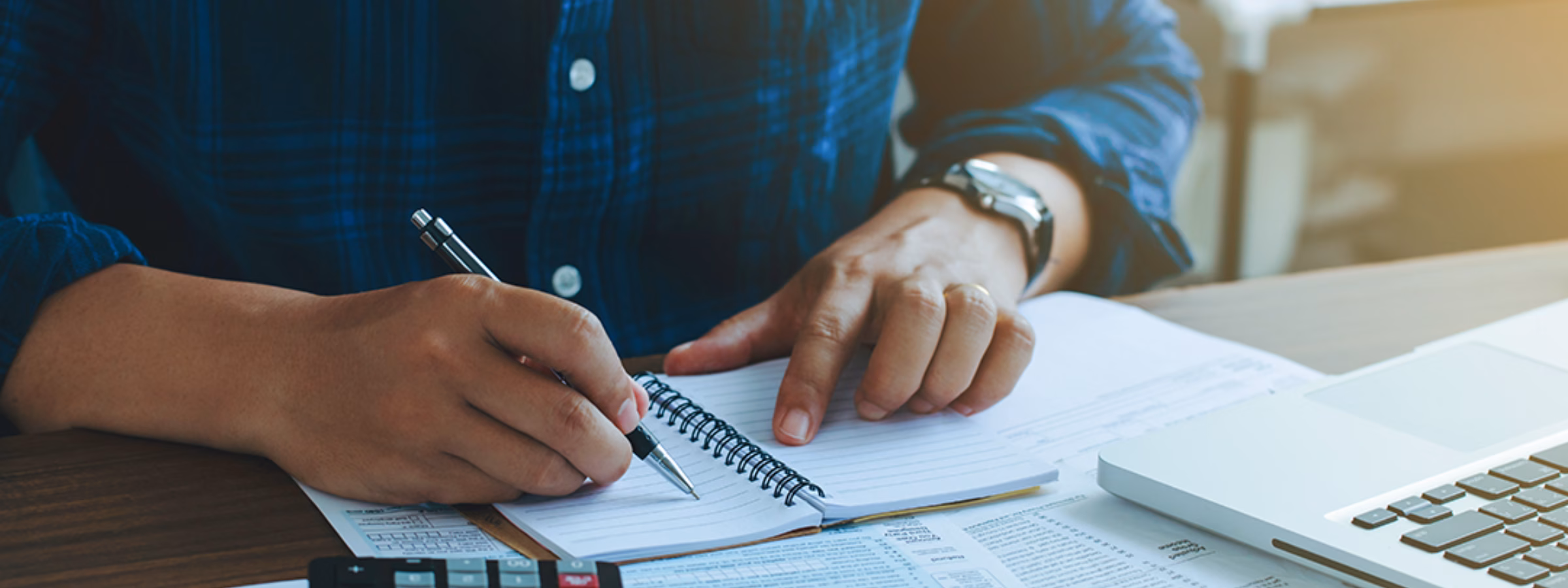 Man doing finances and calculate about cost to real estate investment and in other, tax system.Time for Taxes Money Financial Accounting Taxation Concept