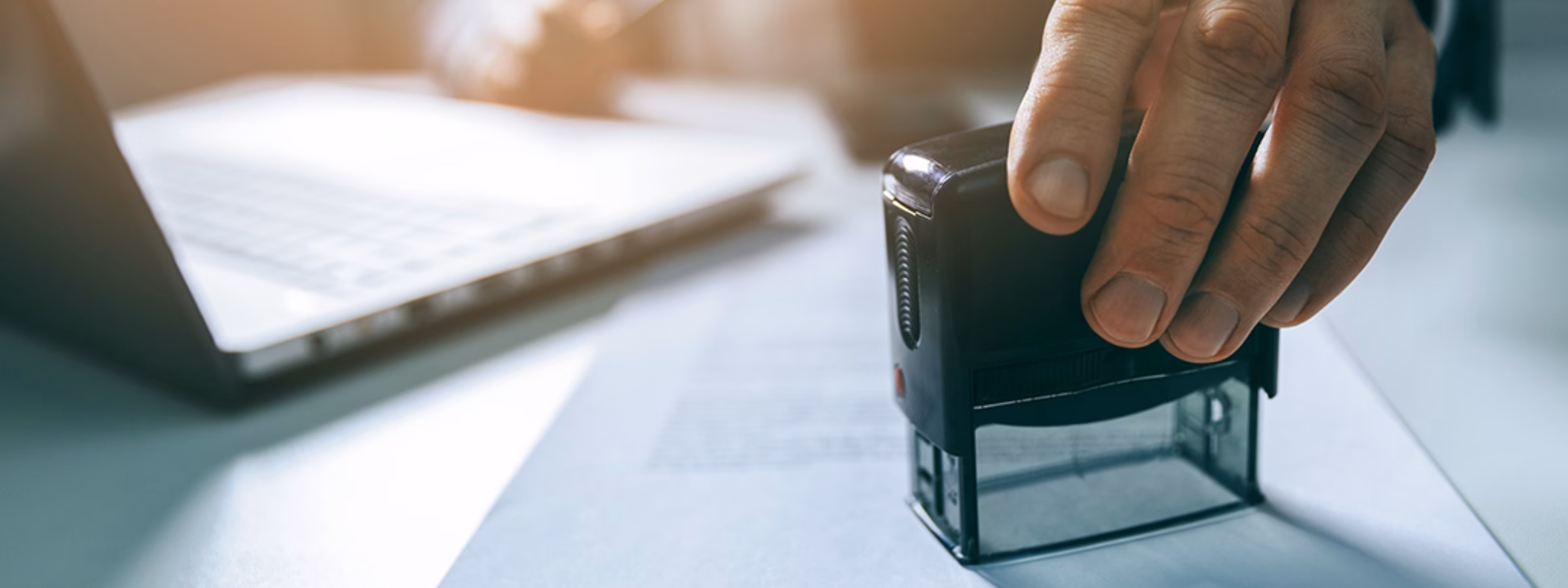 businessman put a stamp on business contract in office