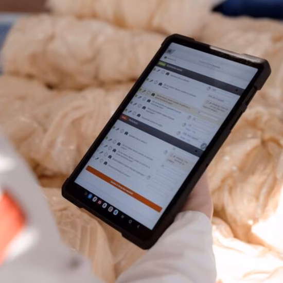 A tablet displays a digital form while being used in a healthcare or home setting.
