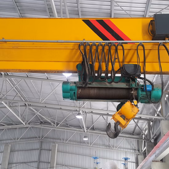 Bovenloopkraan met elektrische takel in een industriële hal voor het verplaatsen van zware lasten.