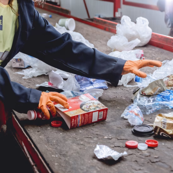 Workers are sorting trash for separate collection and processing.