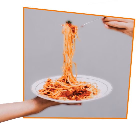 A fork is lifting a bite of spaghetti from a plate.