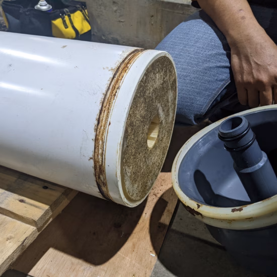 A water filter cartridge being replaced, highlighting the process of maintaining a clean water supply.