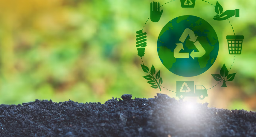 Recycling symbol above fertile soil with icons representing the circular economy and sustainability in a green, natural setting.